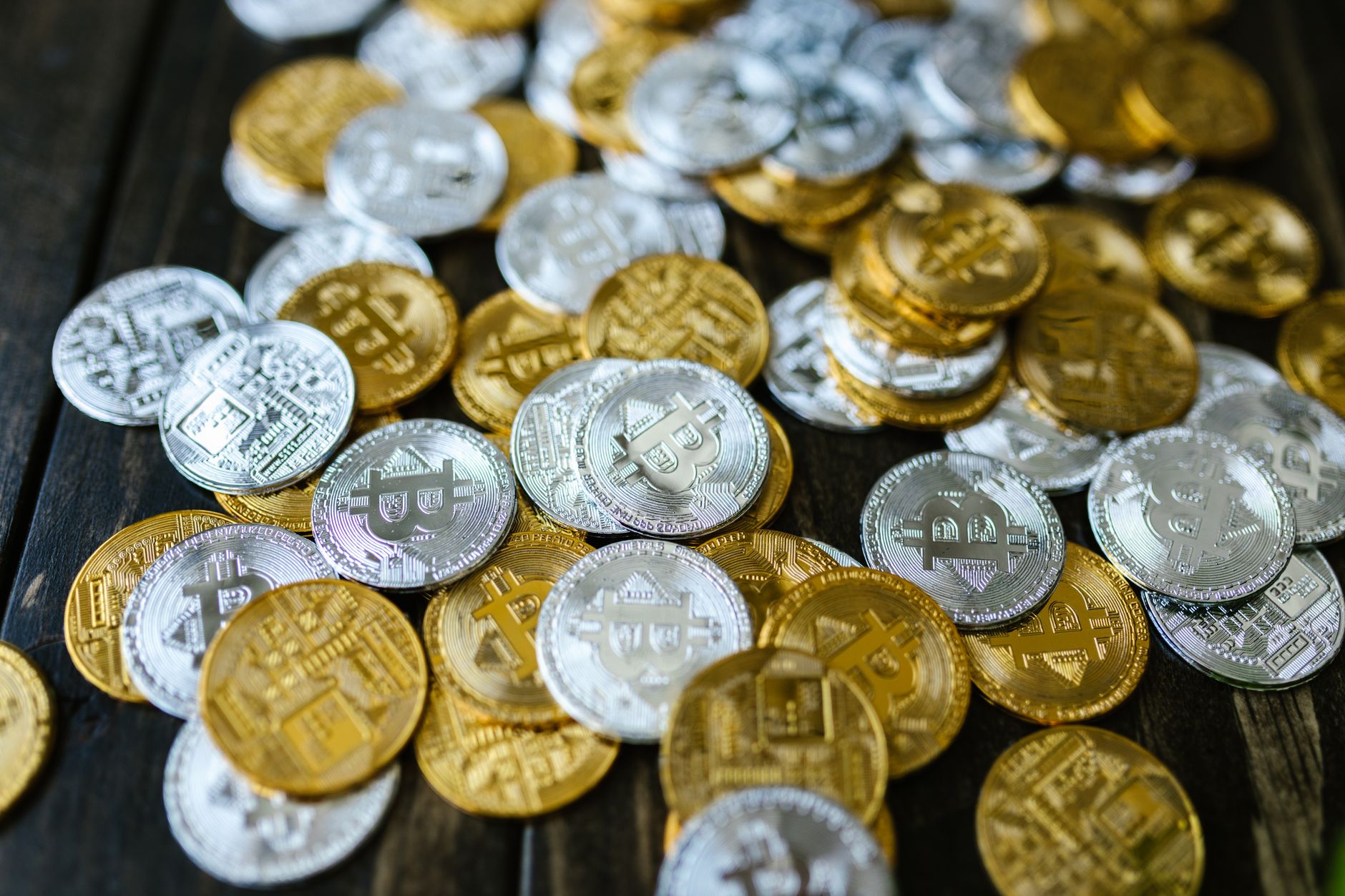 Assorted cryptocurrency coins representing the memecoin market category