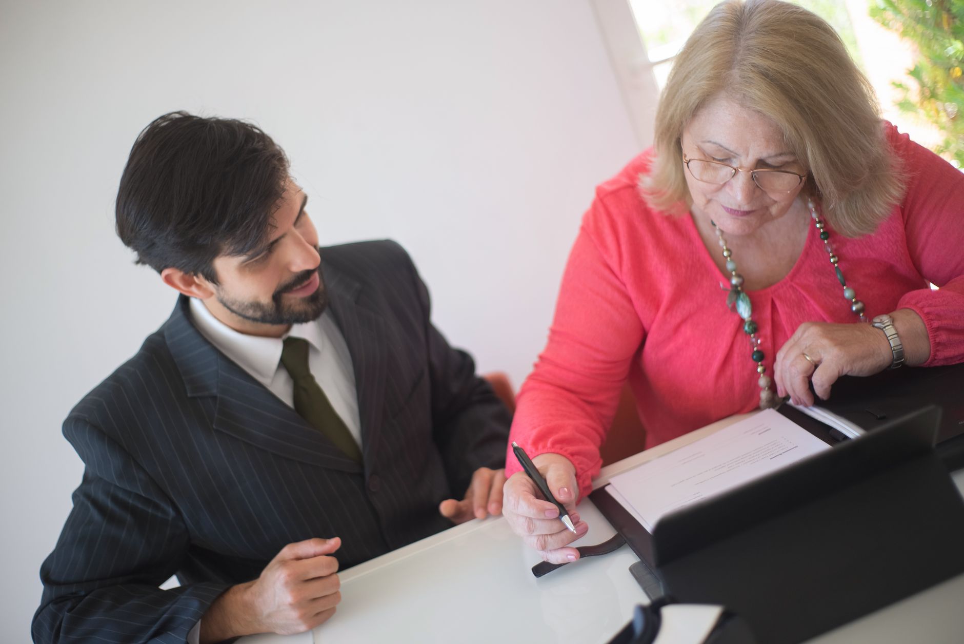 Business professionals reviewing a secured lending agreement at a conference table