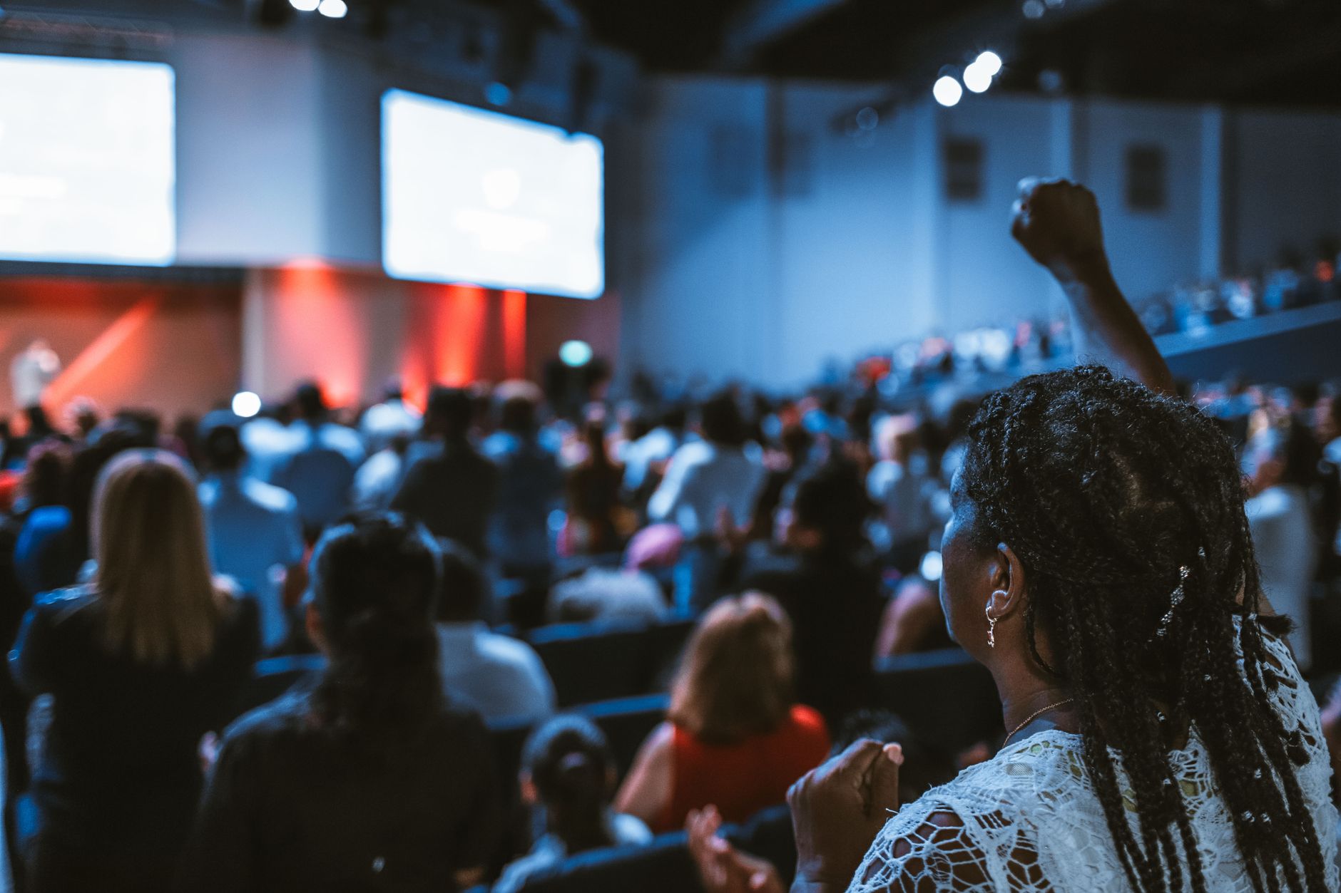 Executive speaking at a technology conference main stage