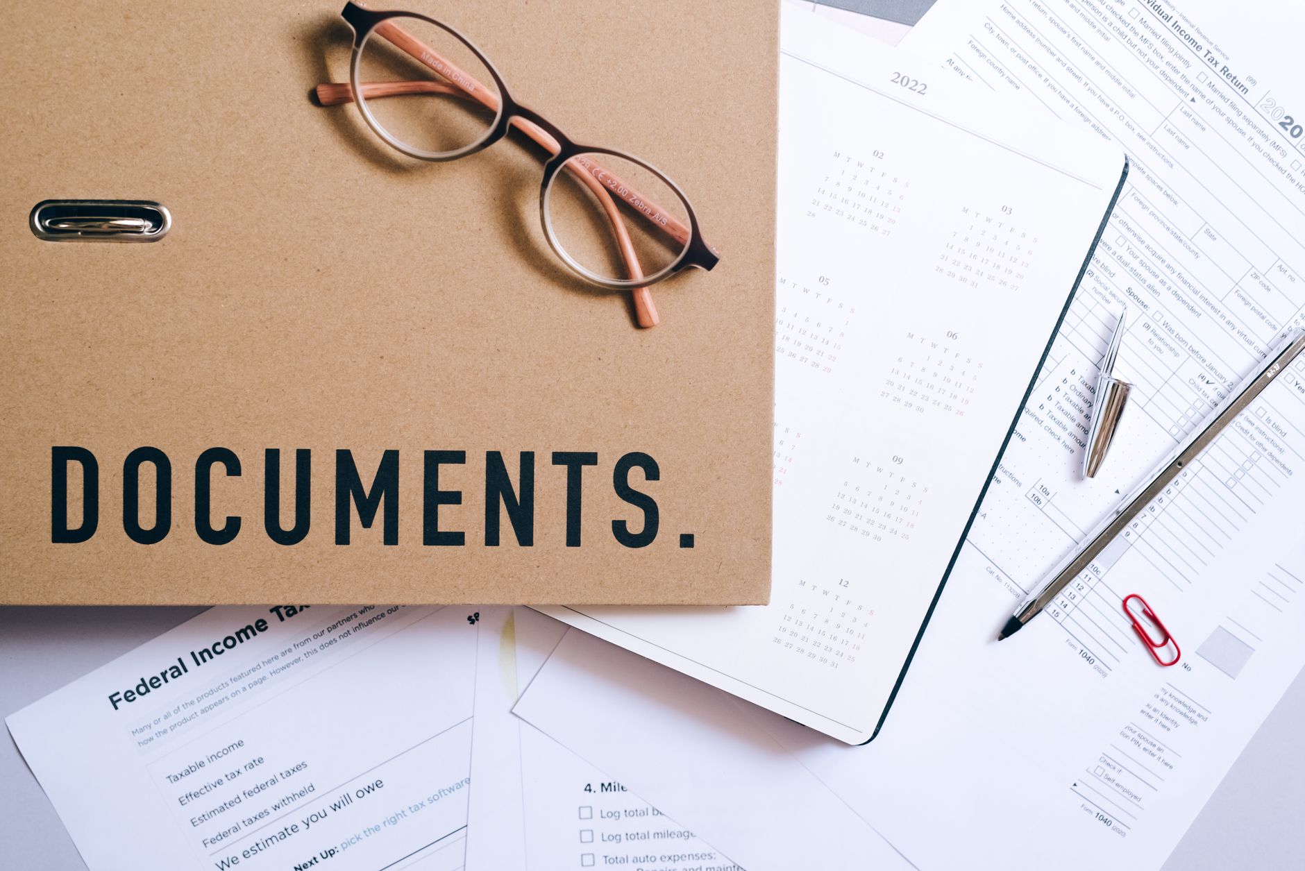 Business professionals reviewing financial compliance documents at a conference table