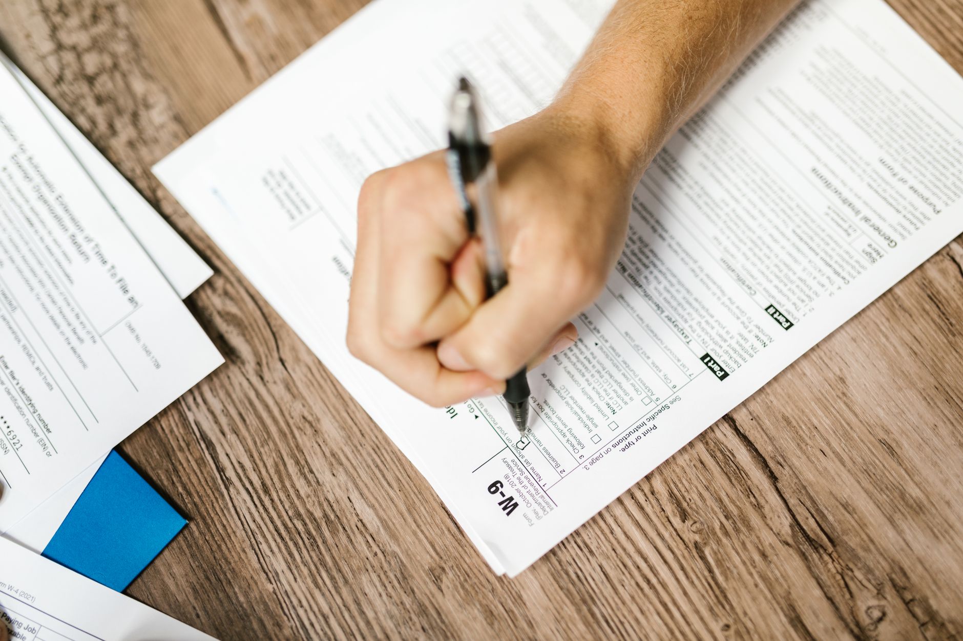 Person reviewing financial regulatory documents at a desk