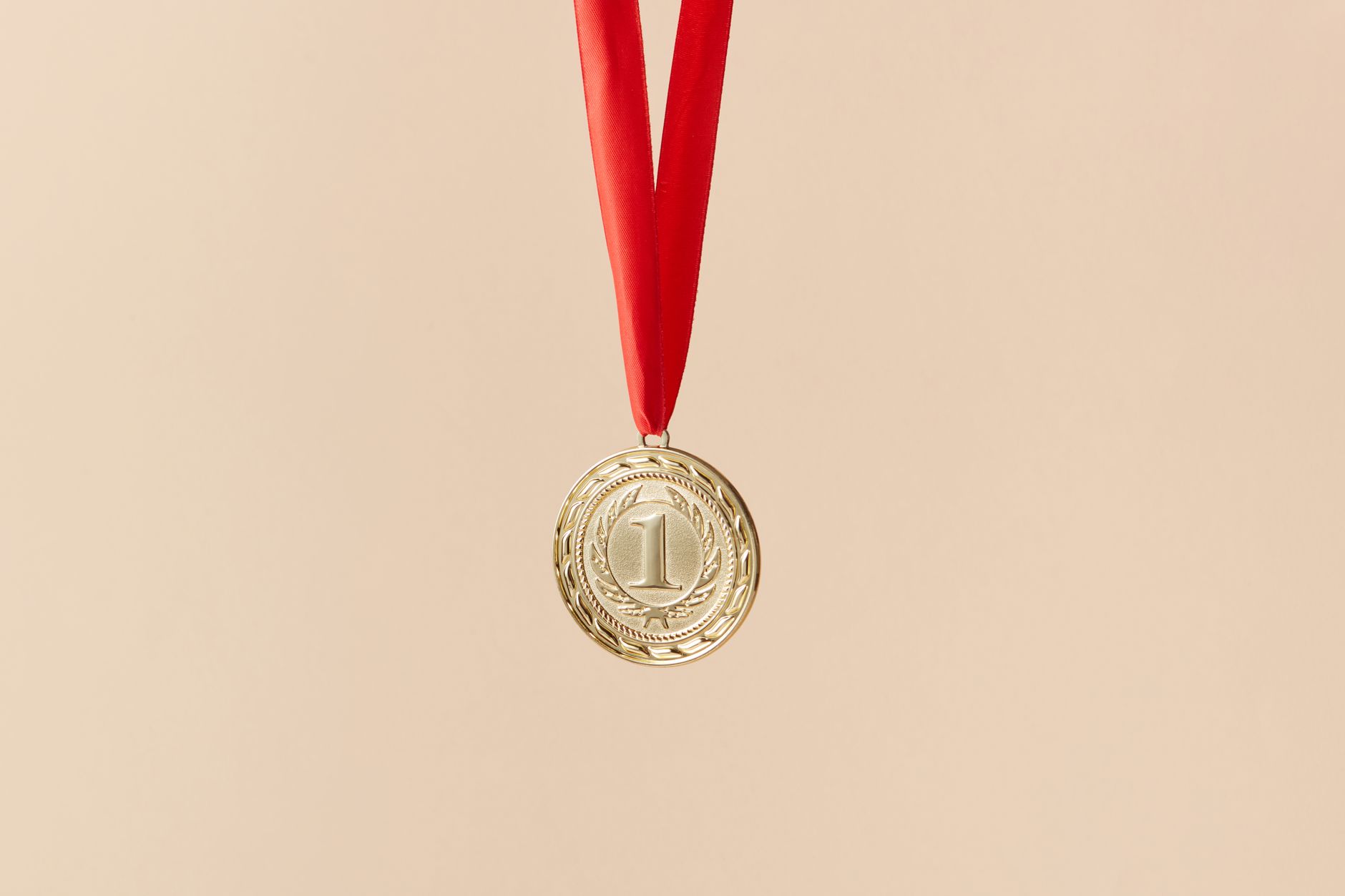 A gold medal representing an academic prize award with Latin inscription
