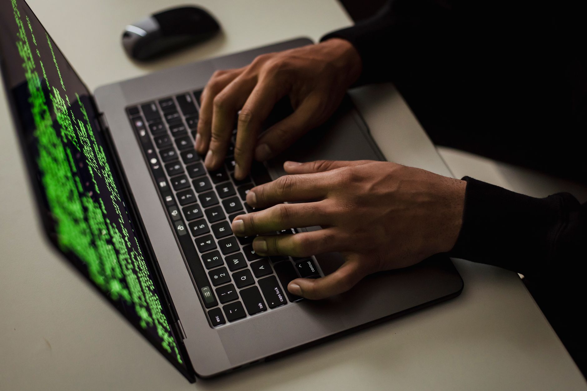 Employee at computer workstation representing insider access and internal compliance risks at financial firms
